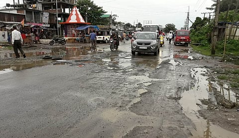 Big potholes on NH-37 road in front of Demow Sitala Mandir irks local people