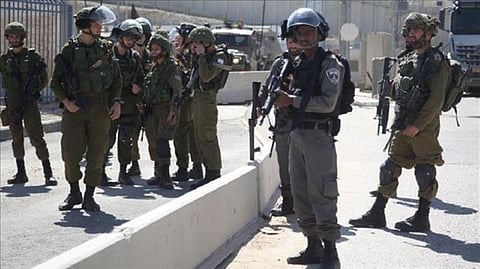 Israeli forces arrest two Palestinians during pre-drawn military raids in West Bank