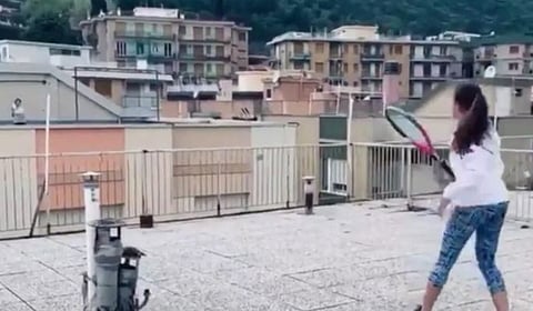 Coronavirus pandemic: Two Italy women play rooftop tennis maintaining social distance