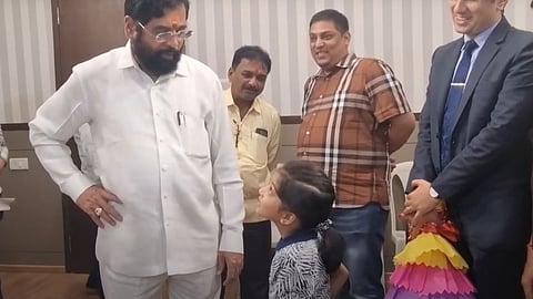 Eknath SHinde talking to a childe