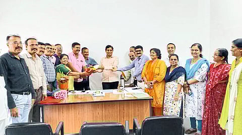 Officers and staff greeting Prakash Deshmukh after accepting the additional post of Registrar of YCMOU