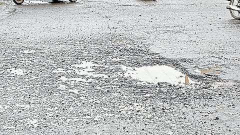 Potholes on the road at Ganjmal signal.