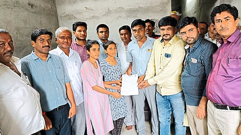 Members of the Baliraja family giving fixed deposit receipts of one lakh each to the sisters as a wave.