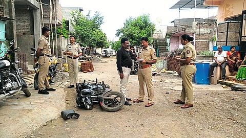 Police officer Sachin Bendre and his colleagues inspecting the incident site on Thursday after a clash between two groups in Nagaon Bari area.