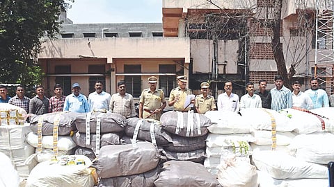 Police officers and action team inspecting gutkha seized by LCB