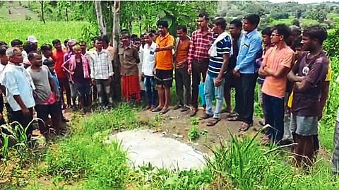 The girl's father and villagers show the field where the girl's body was buried in Salt.