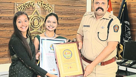 District Superintendent of Police Sachin Patil handing over the Wonder Book of Records certificate to Warli painter Shraddha Karale, ami tease.