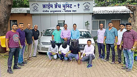 Police team with arrested suspects.