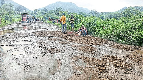 Temporary repair work is in progress by adding mud and gravel.