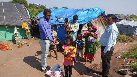 Dr Pathan giving goods on eve of Diwali Festival