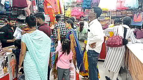 Crowd in the shop to buy clothes.