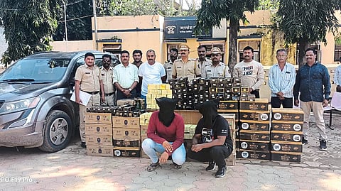 Suspect accused with liquor seized in police action. including police officers and staff.