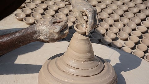 Artisans making clay lamps.