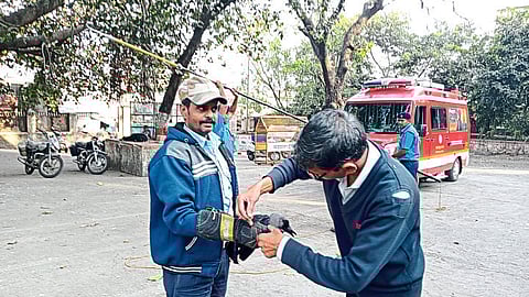 Nashik: Fire department personnel freeing a crow from a noose of nylon netting