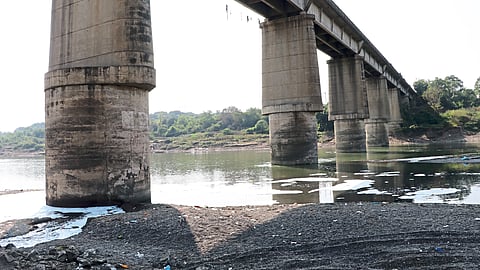 Bridge pillars exposed due to sand erosion.