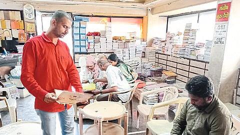 Consumers while choosing wedding cards from different types of albums.