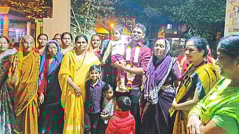 Deore family and well-wishers expressing happiness after Tushar Deore from Regaon was selected for the post of sales tax inspector in the Public Service Commission examination.