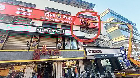 Removing the name from the plaque on the Shiv Sena Bhavan with the help of a crane.