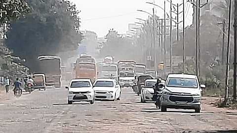 Dust spreading in the area due to the release of mud and soil from the potholes on the road