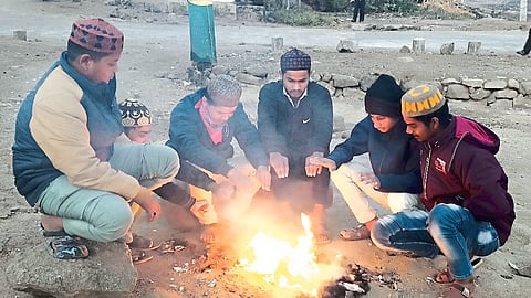 There is a picture of bonfires burning at the intersections in the city as the temperature drops.