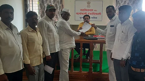 Taluka President of NCP Chitaman Gavit while presenting the statement of demand to Surgana Tehsildar Sachin Mulik.