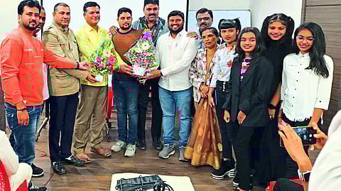 Former Zilla Parishad members Sandeep Patil, Deva Patil, Vinod Chavan, Sanjay Fatnani while felicitating Tushar Balchi, the lyricist of the rap song that defines the identity of Malegaon.