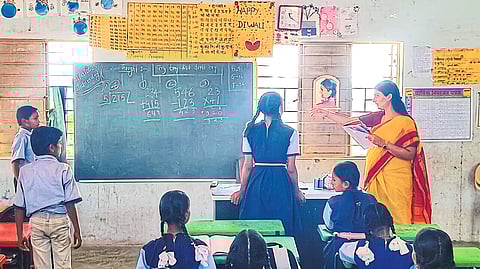 Ashima Mittal studying from the students of Zilla Parishad school here.