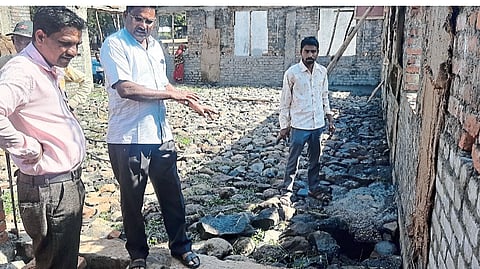 Chowdhury and villagers, members of the school management, while showing the shoddy work of the school in Palasan.