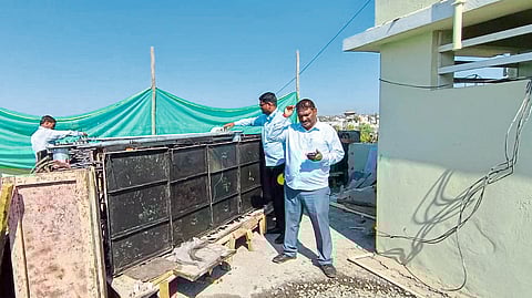 The municipal team while inspecting the mobile tower being erected without permission on the building on Wadibhokar road in the city.