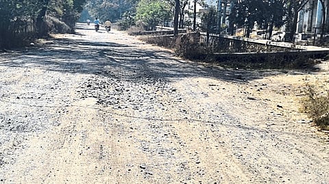 Potholes on the road leading from the market committee to the rural hospital.