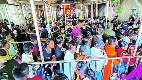 A procession of devotees in the temple hall.