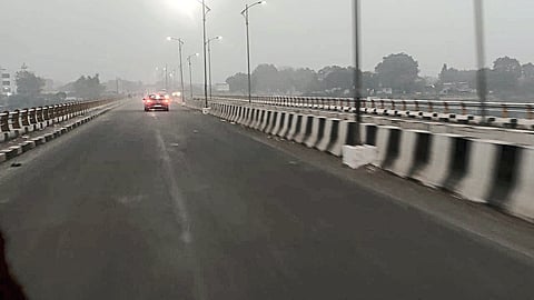 Highway over mill bridge lost in fog.