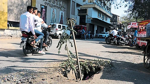 A pit in the middle of the road near the Municipal Corporation.