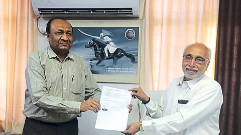 Administrator Pratapsinh Chavan while receiving instructions from outgoing administrator Arun Kadam of District Central Co-operative Bank.
