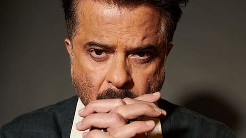 Anil kapoor holds hand of woman on turbulent flight