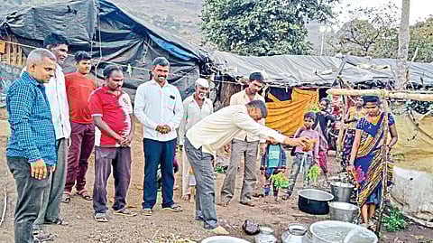 Tribal brothers of the settlement along with cooperation officer Vasant Gawli while worshiping the water of Kupanlake here