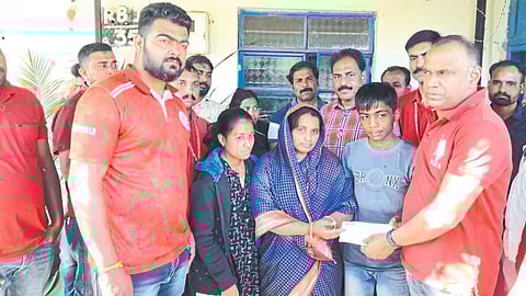 Venu P Nair while giving a relief check of one lakh rupees to the families of those who died in the railway accident. .