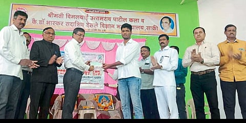 While giving a check to Krishna Kuvar in Bimalbai College, Dr. Ahire, Principal Sonwane.