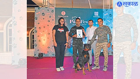 While awarding the title of Best Dog in Dog Show to Google and Handler Ganesh Konde, Arun Chavan of Nashik City Police Commissionerate, Dr. Digvijay Patil.