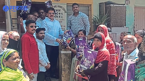 MLA Suresh Bhole while giving happiness ration to the beneficiary at the ration shop.