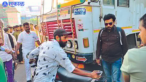 After an accident at Nehru Chowk, a citizen lifts a two-wheeler from a container and moves it aside.