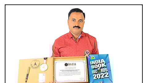 Dyaneshwar Sonwane showing the certificate of inclusion in the 'India Book of Records'.
