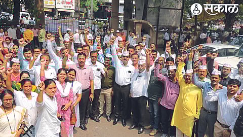 Zilla Parishad employees making an announcement in front of the Zilla Parishad entrance on Tuesday, participating in the indefinite strike of state government employees.