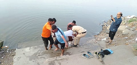 Volunteers of wildlife organization removing dead bodies from the lake.