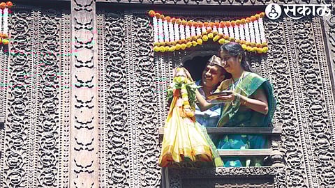 Women worshiping a traditional Gudi set up outdoors on Gudi Padva.