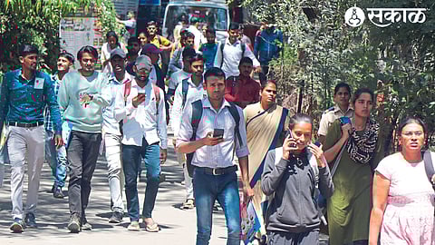 Candidates exiting the examination center after the written paper at KTHM College on Sunday.