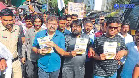 Former minister Jitendra Awad protesting with the constitution in his hands on Saturday regarding the Vedokta and Puranokta dispute at Srikalaram temple.