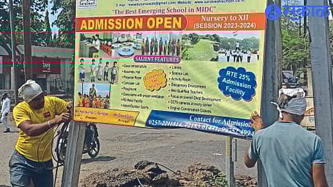 Municipal employees removing unauthorized billboards in the city.