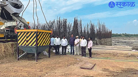 Officials and villagers present at the start of concreting of the dam pillar.