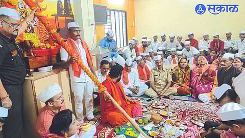 Eknath Gawli hoisting the flag on the peak and family members during the flag pooja at the trust office